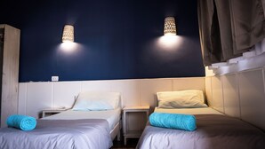 A room with two beds, a nightstand, and a wall-mounted lamp. - Eldorado Lodge & Restaurant (Dahab)