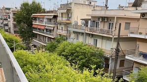 A residential area with multi-story buildings, balconies, and satellite dishes. - Modern, Centrally Located Apartment (Thessaloniki)