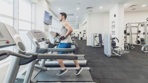 A gym with treadmills, weight machines, and a large window. - MERDZ Spa & Fitness Sky Resident  (Skopje)