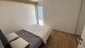 Une chambre à coucher avec un lit, une fenêtre et une porte.