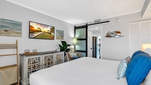 A modern bedroom with a large bed, a wooden sideboard, and artwork on the walls. - Oceanfront Updated Condo at SeaWatch Resort 6 Pools 10 Hot Tubs Balcony King Bed (Myrtle Beach)