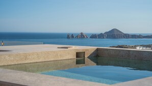 A swimming pool with a view of the sea and rocky formations. - Mistiq Los Cabos  (Cabo San Lucas)