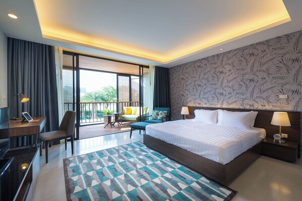 Relax in a stylish room with a large bed, desk, and seating area, offering a balcony with city views and a leaf-patterned design.