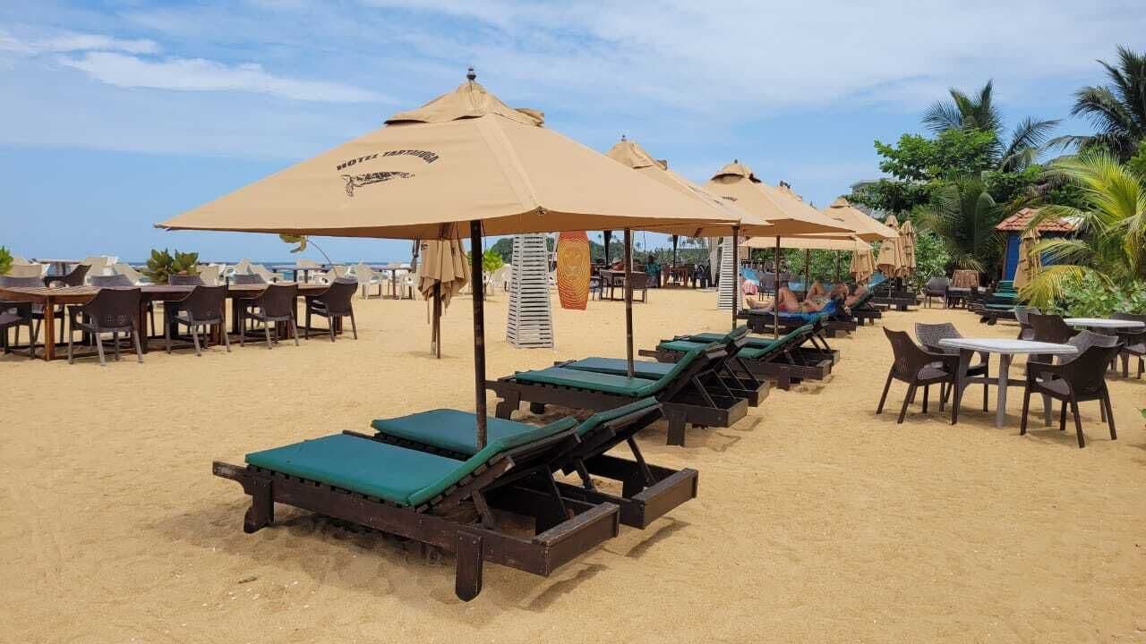 On the beach, white sand, sun-loungers, beach umbrellas