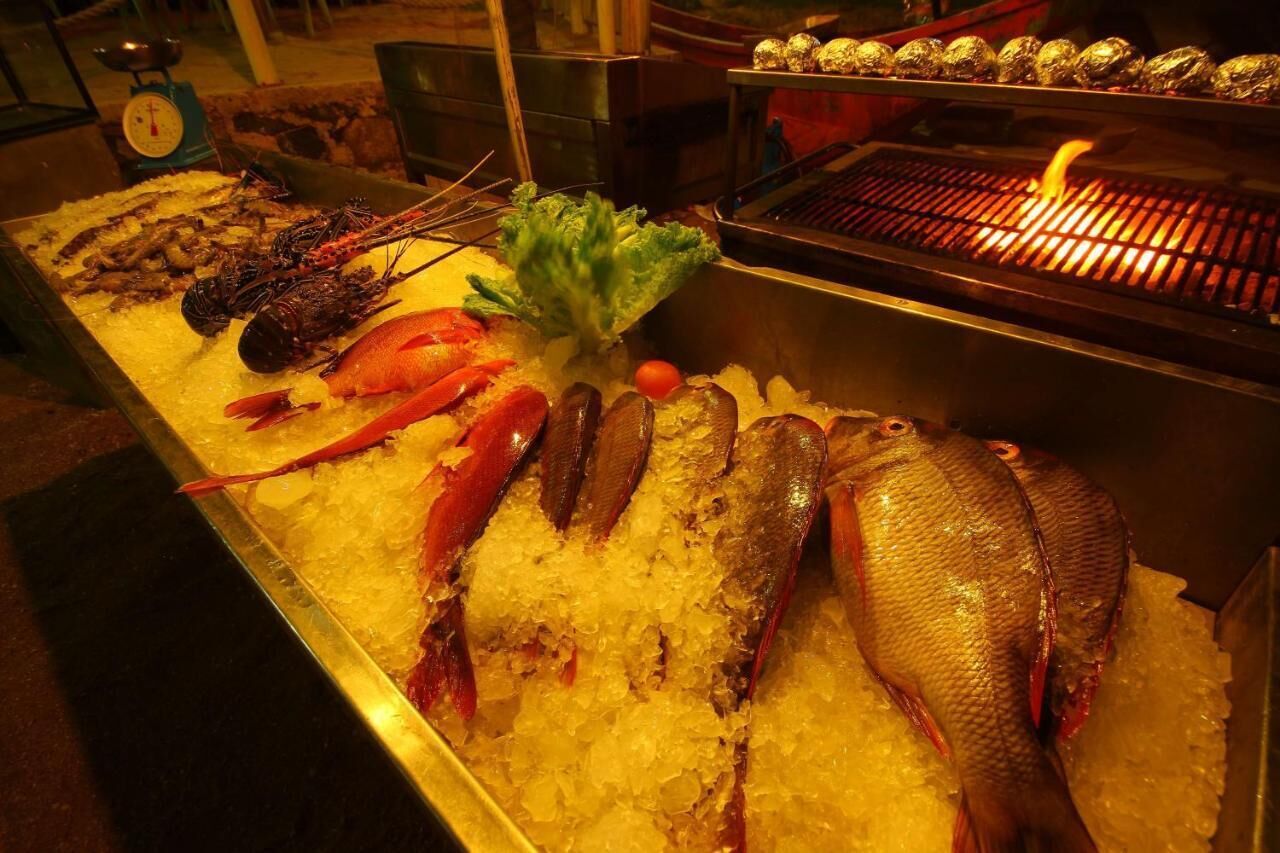 A seafood display with various types of fish and shellfish on ice.