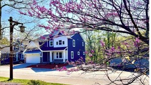 A two-story house with a front porch, a garage, and a driveway. - SoHappy Haven - 6 bdrm, Game Room, Year Round Pools, Hot Tub, Marina & Clubhouse (South Haven)