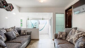 Una sala moderna con dos sofás, una mesa de centro y un ventanal con vistas.