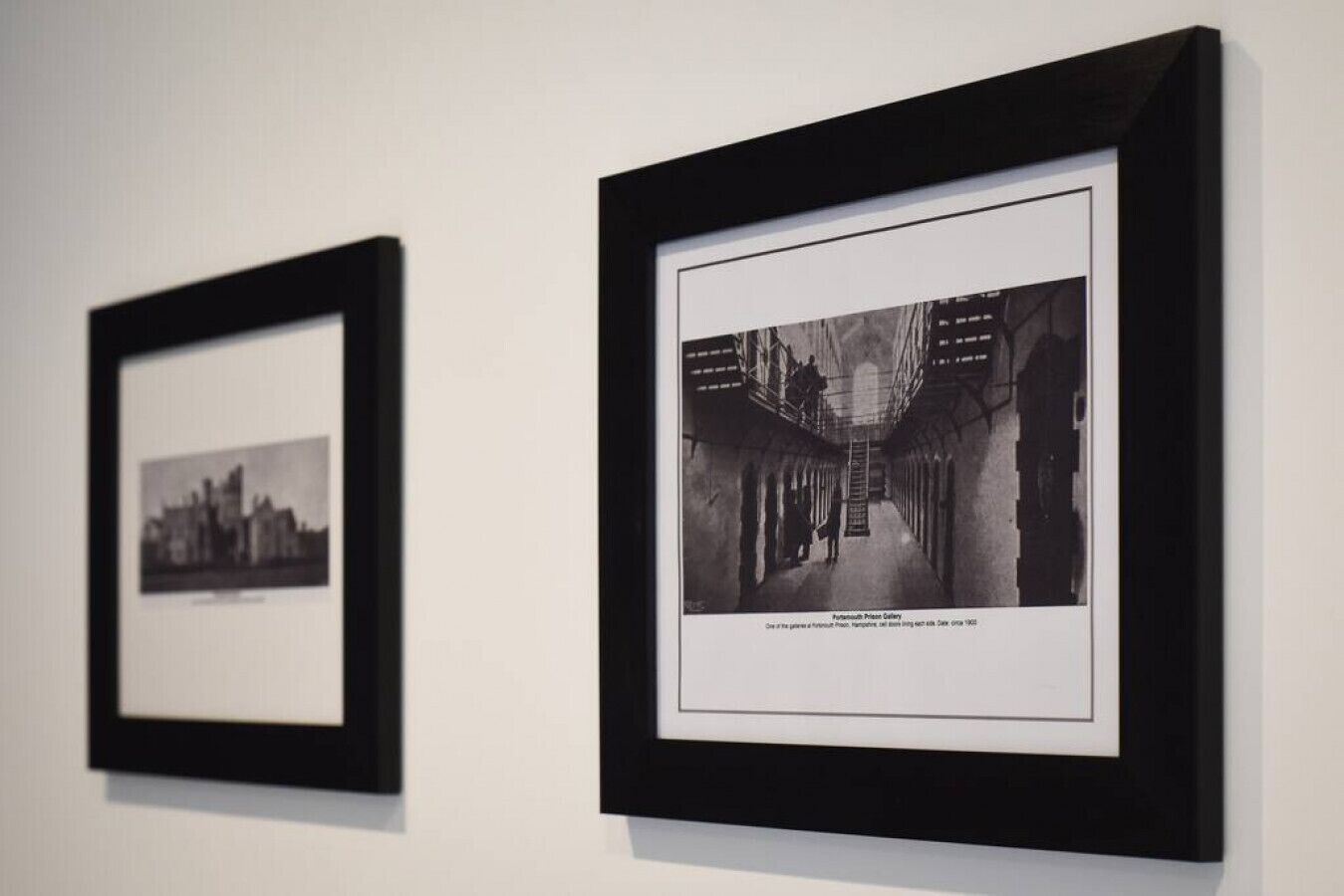 Two framed photographs on a wall.