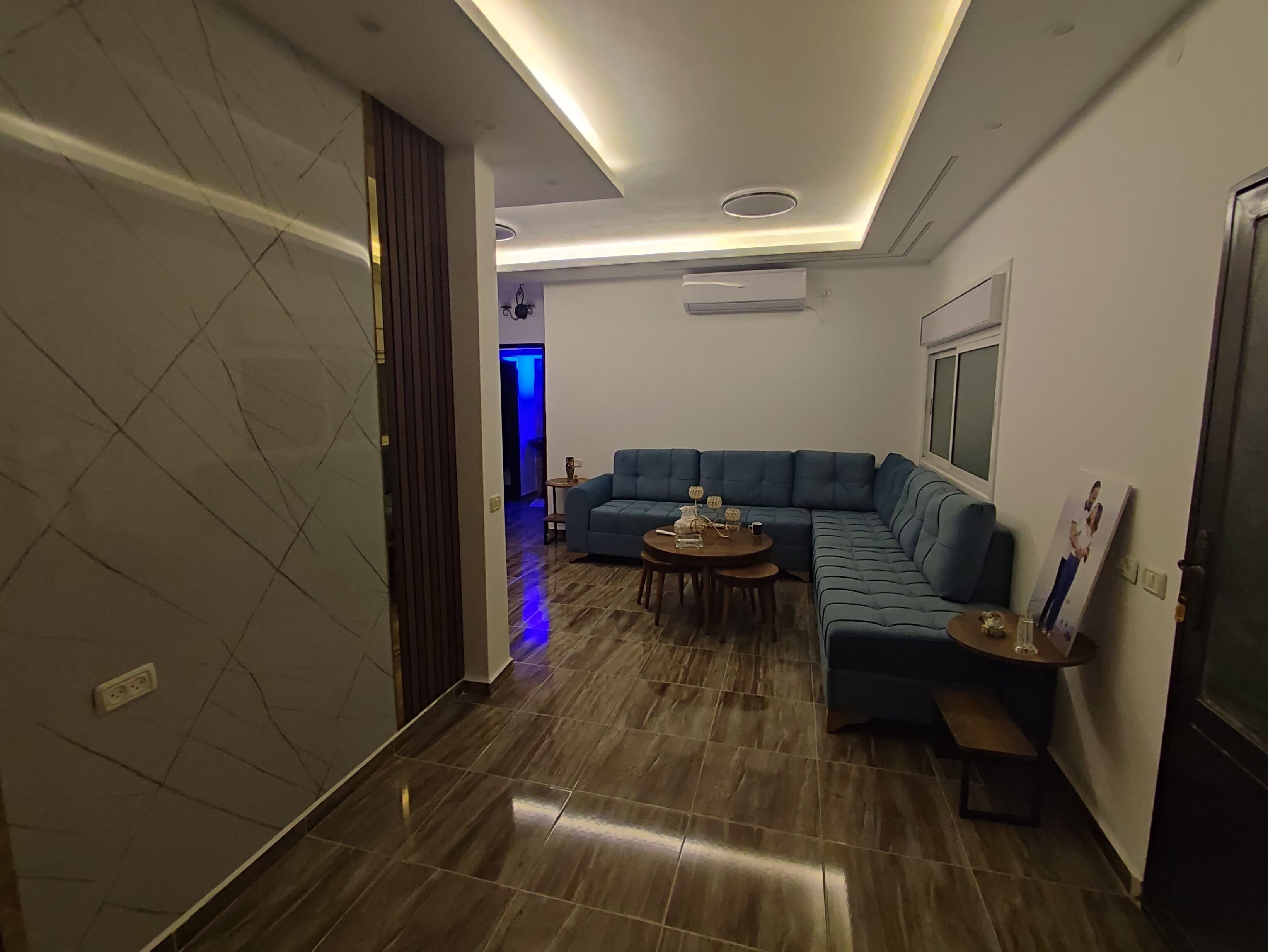 A modern living room with a sectional sofa, a coffee table, and a bench.