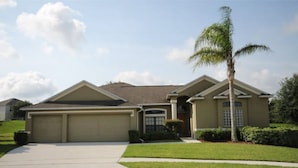 A two-story house with a garage, a front porch, and a well-maintained lawn. - Mushu's Temple 122LP (Davenport)