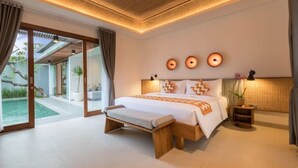 A modern bedroom with a large bed, a bench, and a view of a pool and garden.