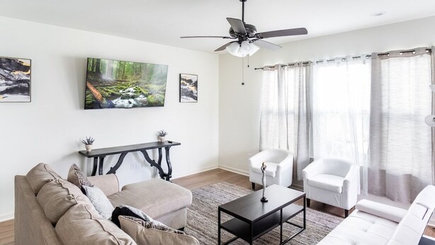 A living room with a sofa, armchairs, a coffee table, and artwork on the walls. - Tiger Stadium Oasis in Baton Rouge by LSU - CB1014 (Baton Rouge)