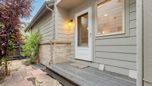 A house with a front porch, a door, and a window. - 1 Mi to Dtwn: Stylish Denver Home w/ Patio (Denver)