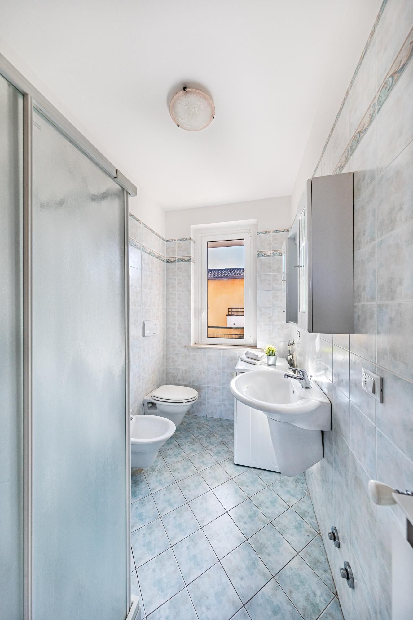 A modern bathroom with a toilet, bidet, and sink.