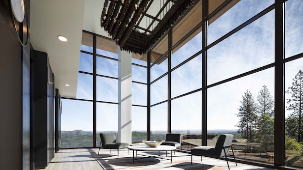 A spacious room with large windows, a modern ceiling design, and a seating area with a coffee table. - Red Hawk Resort & Casino (Placerville)