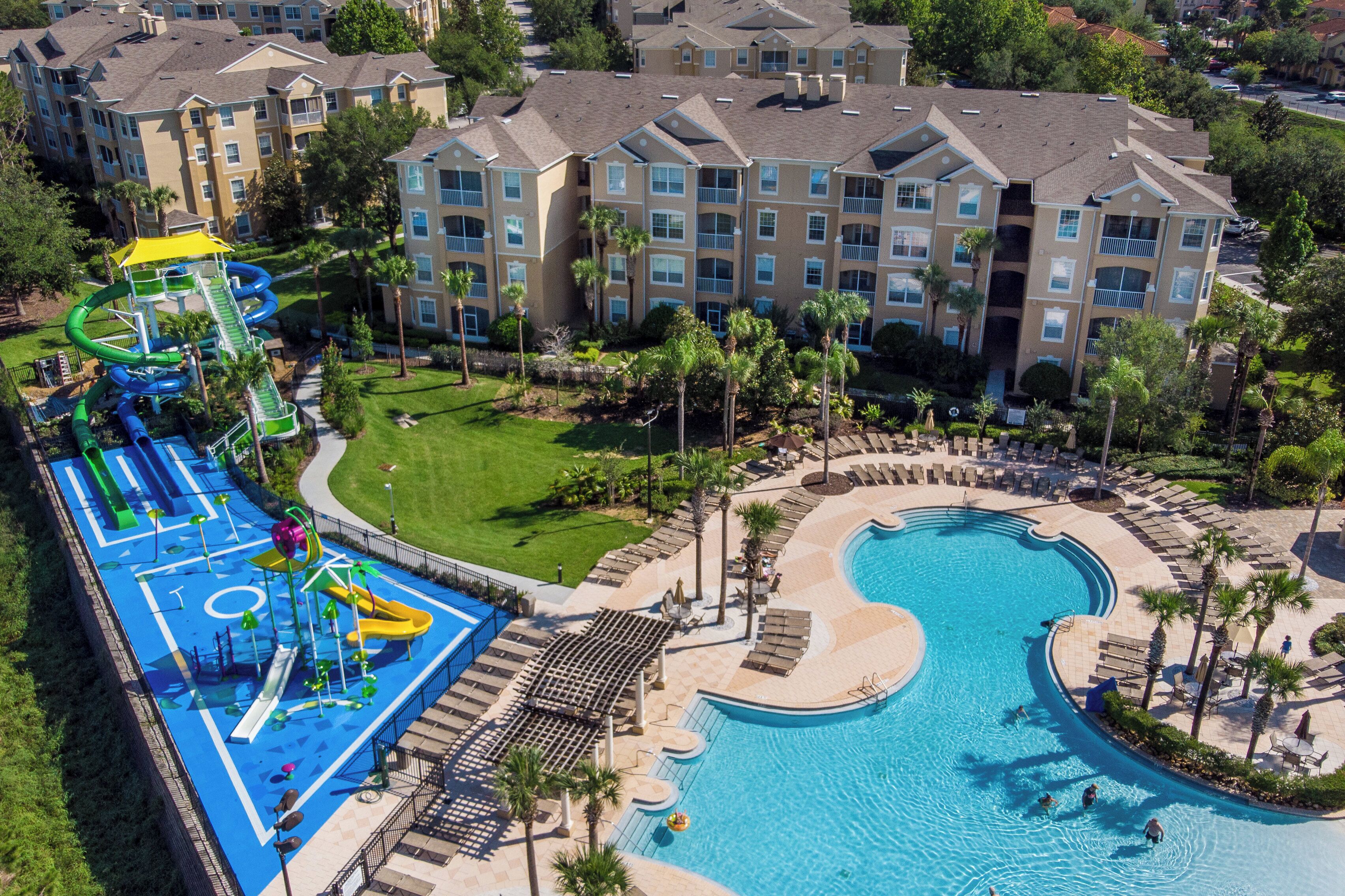A resort with a large pool, a water park, and multiple apartment buildings.