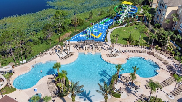 A resort with a large pool, a water park, and a well-maintained lawn area. - Villa Holidays 7704 WH (Kissimmee)