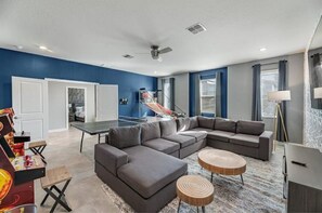 Relax in this stylish living room with a sofa, ping pong table, and coffee table.