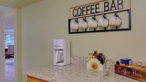 A kitchen with a coffee bar sign, a coffee machine, and a coffee bean display. - The Manhattan Charm! (Manhattan)