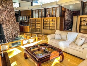 Cozy living room with a fireplace, dining area, and comfortable seating.