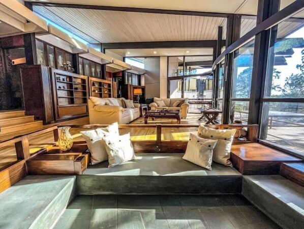 Relax in this inviting space with a sofa, armchairs, and a fireplace.