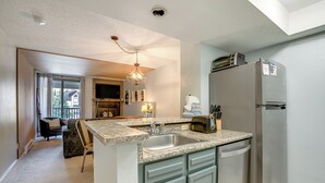 A kitchen with granite countertops, a stainless steel refrigerator, and a built-in dishwasher. - Walk to Ski Lift + Hot Tub: Copper Mountain Condo (Frisco)