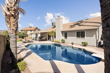 Large private backyard with sparkling pool