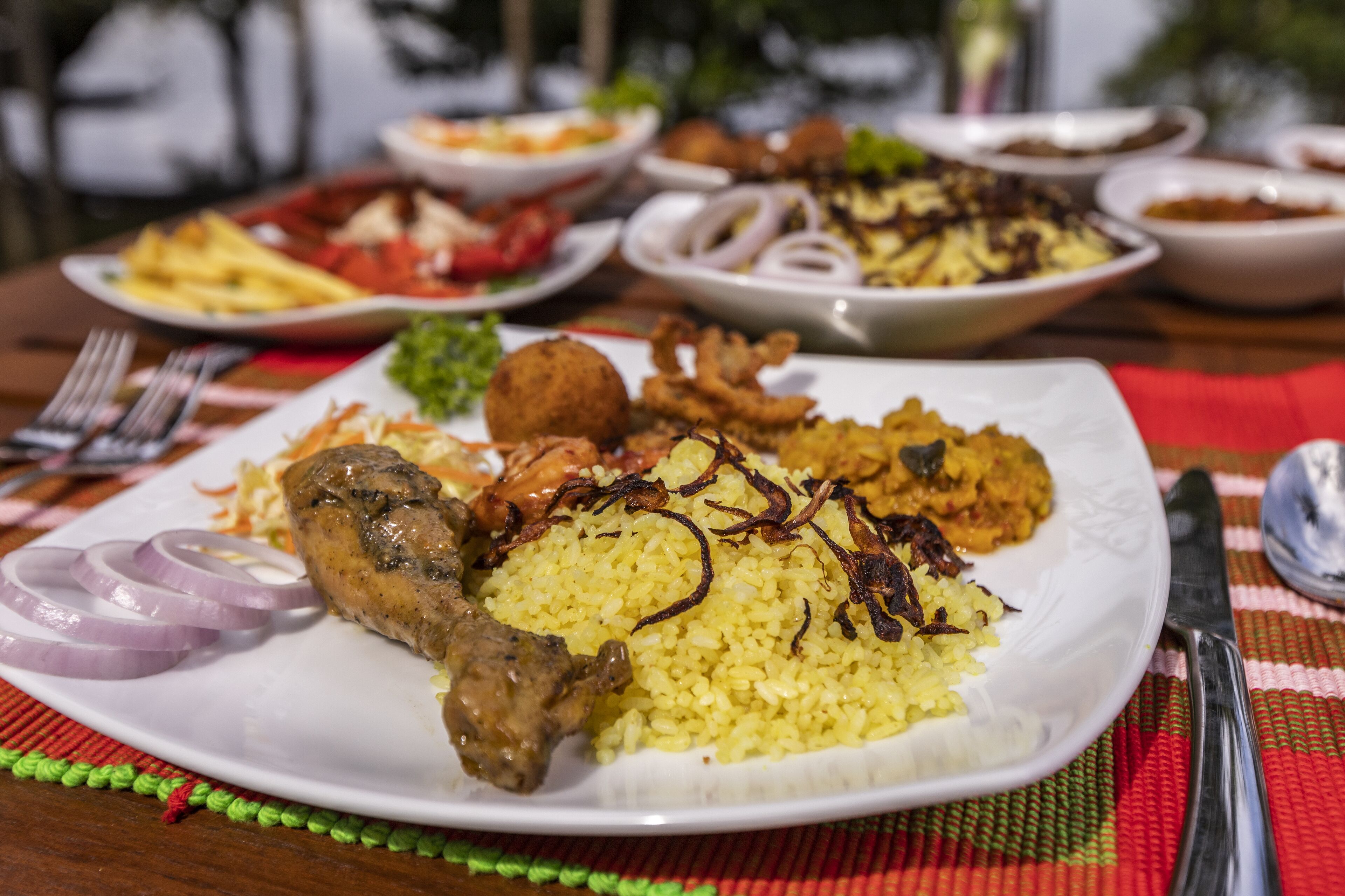 A plate of food with rice, meat, and vegetables.