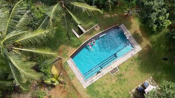 Outdoor pool, open 6:00 AM to 9:00 PM, free cabanas, pool umbrellas