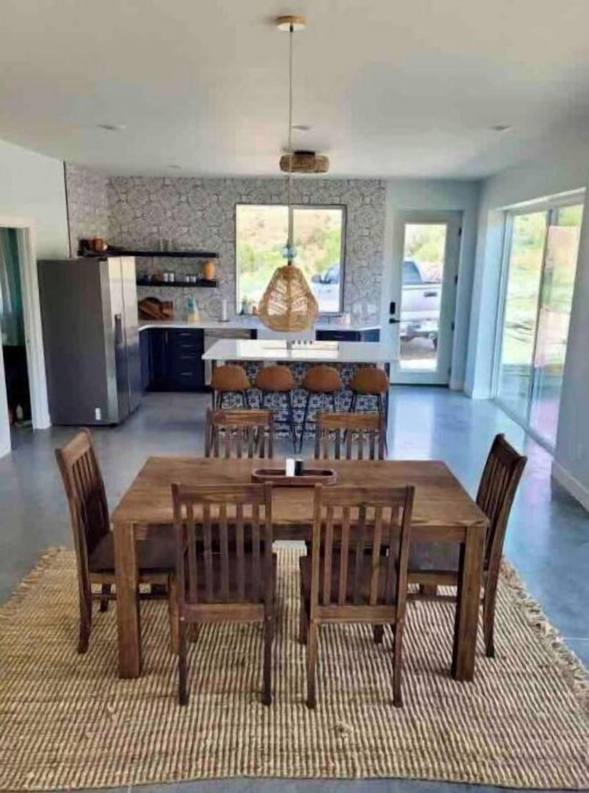 A modern kitchen with a dining area.