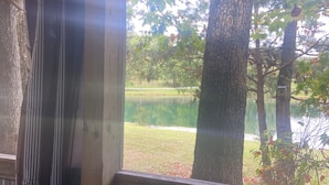 A rustic wooden structure with a view of a lake and trees.