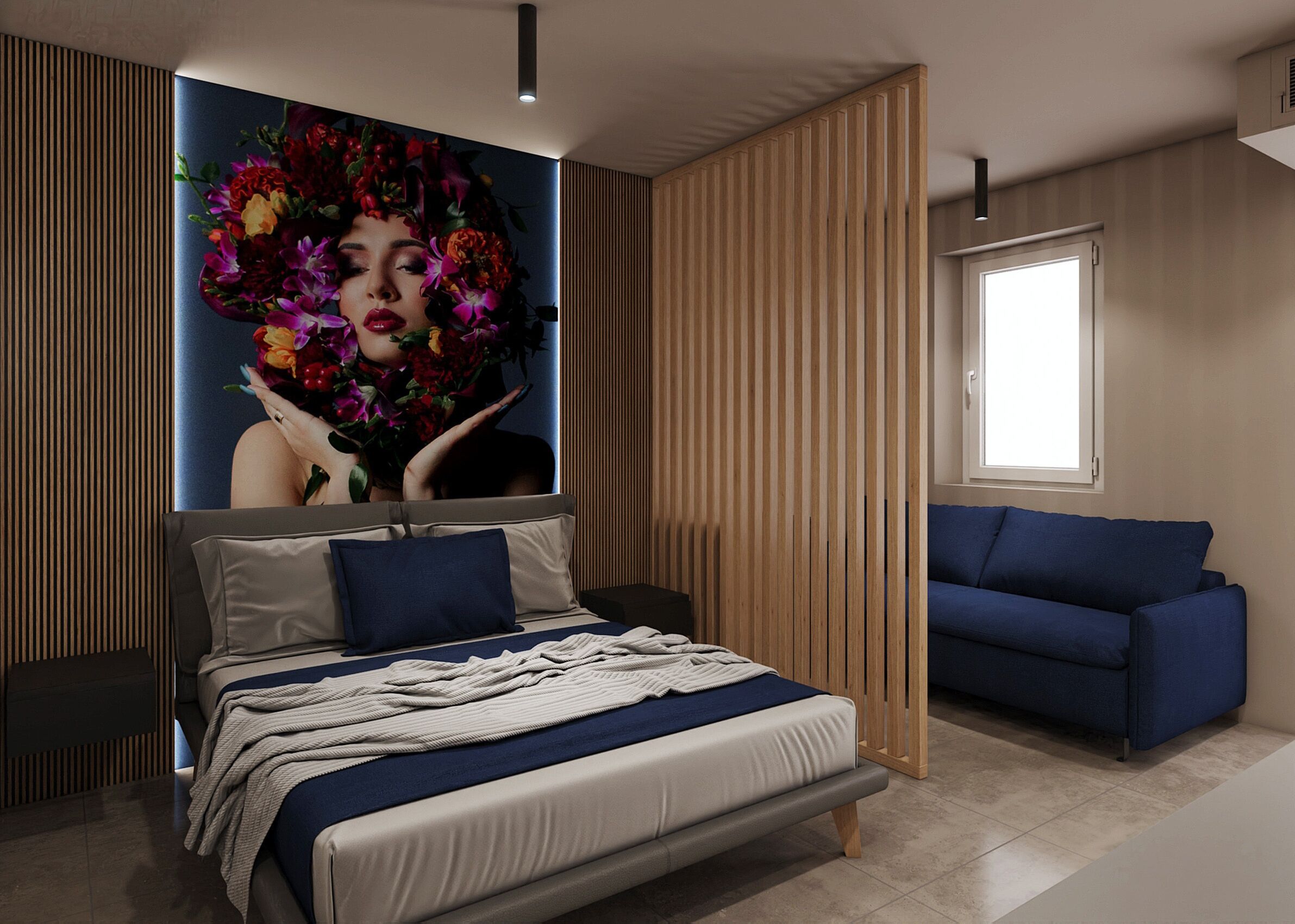 A modern bedroom with a large bed, a blue sofa, and a wall-mounted artwork.