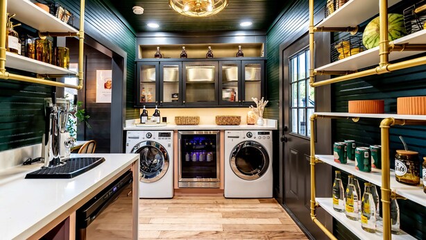A modern kitchen with stainless steel appliances, wooden flooring, and built-in shelving with various kitchen items. - Best Location in Downtown NB Golf Cart Included! (New Braunfels)
