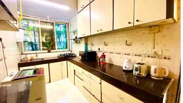 Fridge, microwave, cookware/dishes/utensils, dining tables