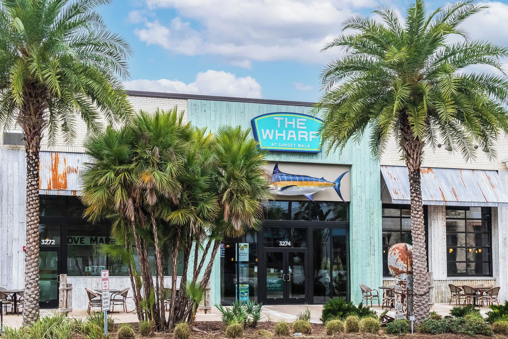 A building with a sign reading "The Wharf at Sunset Walk."