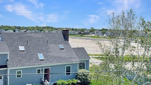 A residential building with a sloped roof, multiple windows, and a visible chimney. - High View at Short Sands - Beautiful condo at Short Sands Beach (York)