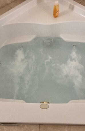 A hot tub with a bottle of bath oil on the edge. - Fully furnished turnkey home located in gated Bermuda Dunes Country Club. (Bermuda Dunes)