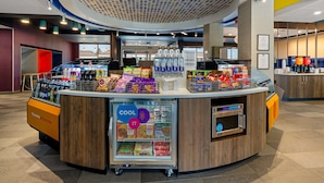 A self-service beverage kiosk with a refrigerated section and a coffee machine. - Tru By Hilton Christiansburg (Christiansburg)