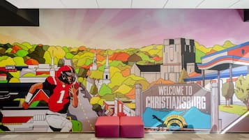 Um mural com um jogador de futebol e uma placa de boas-vindas a Christiansburg.