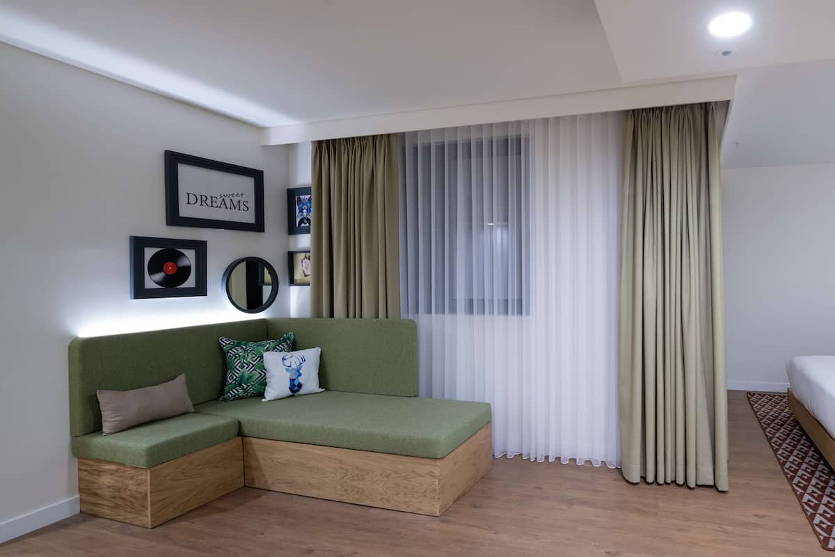 Habitación, 1 cama de matrimonio grande con sofá cama, no fumadores | Zona de estar | Una televisión