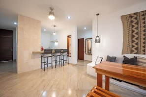 Contemporary living space with a dining area, seating area, and kitchen.