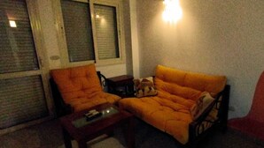 A room with a sofa, a chair, and a small table. - 2-Bed property in Makadi Heights (MAKADI BAY)