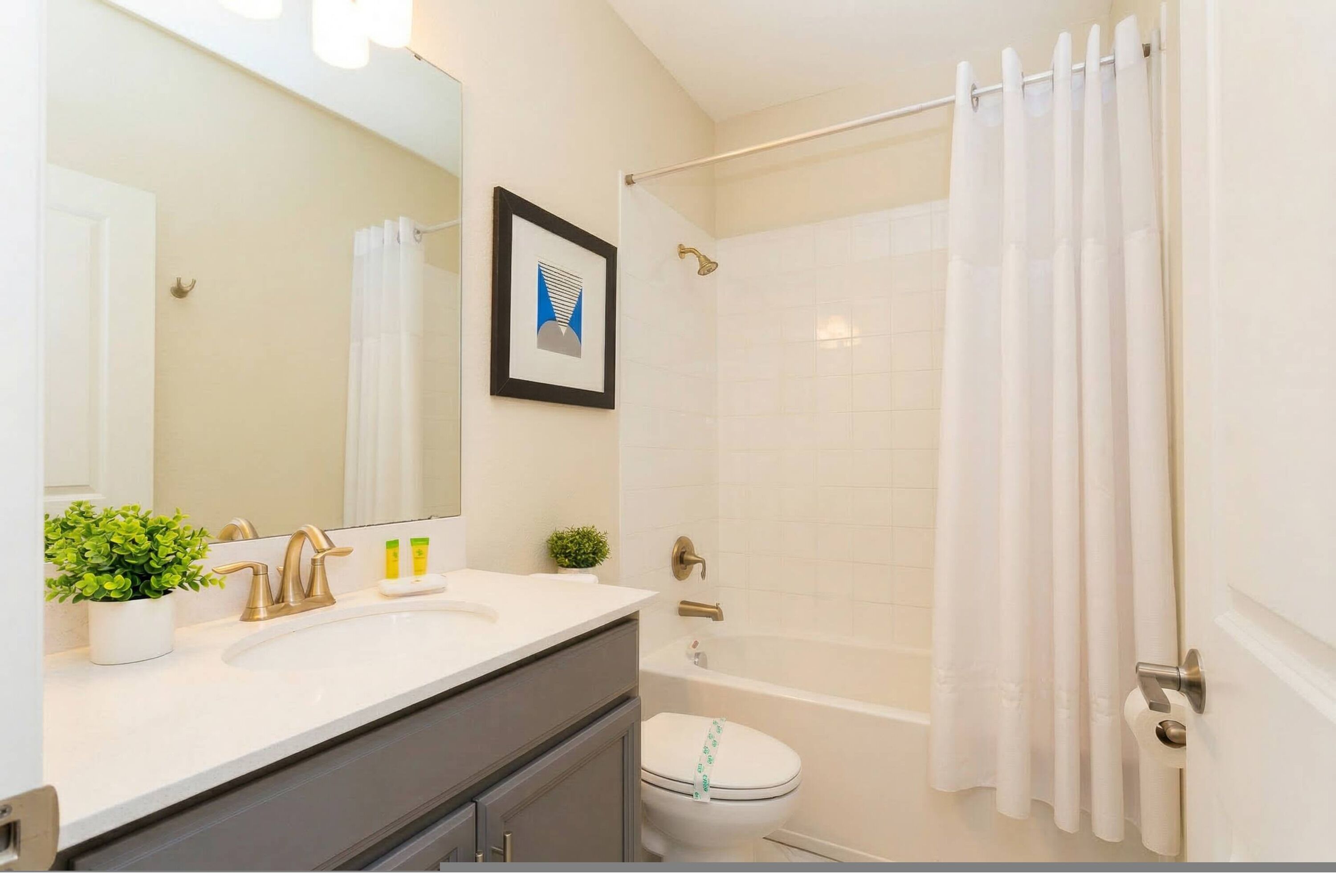 A bathroom with a bathtub, toilet, and sink.
