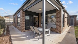 A modern house with a covered patio, large windows, and a brick exterior. - Seagrove Getaway in Cowes (Cowes)