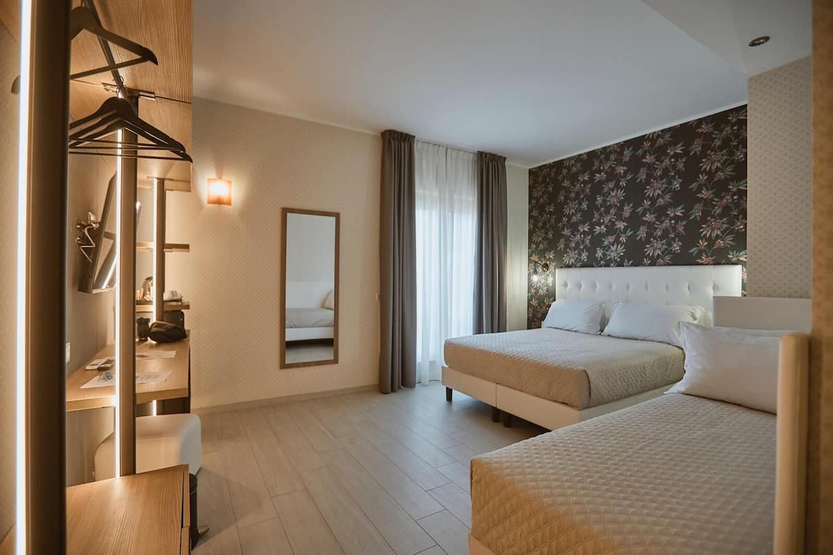 Deluxe driepersoonskamer | Luxe beddengoed, donzen dekbedden, een kluis op de kamer, een bureau