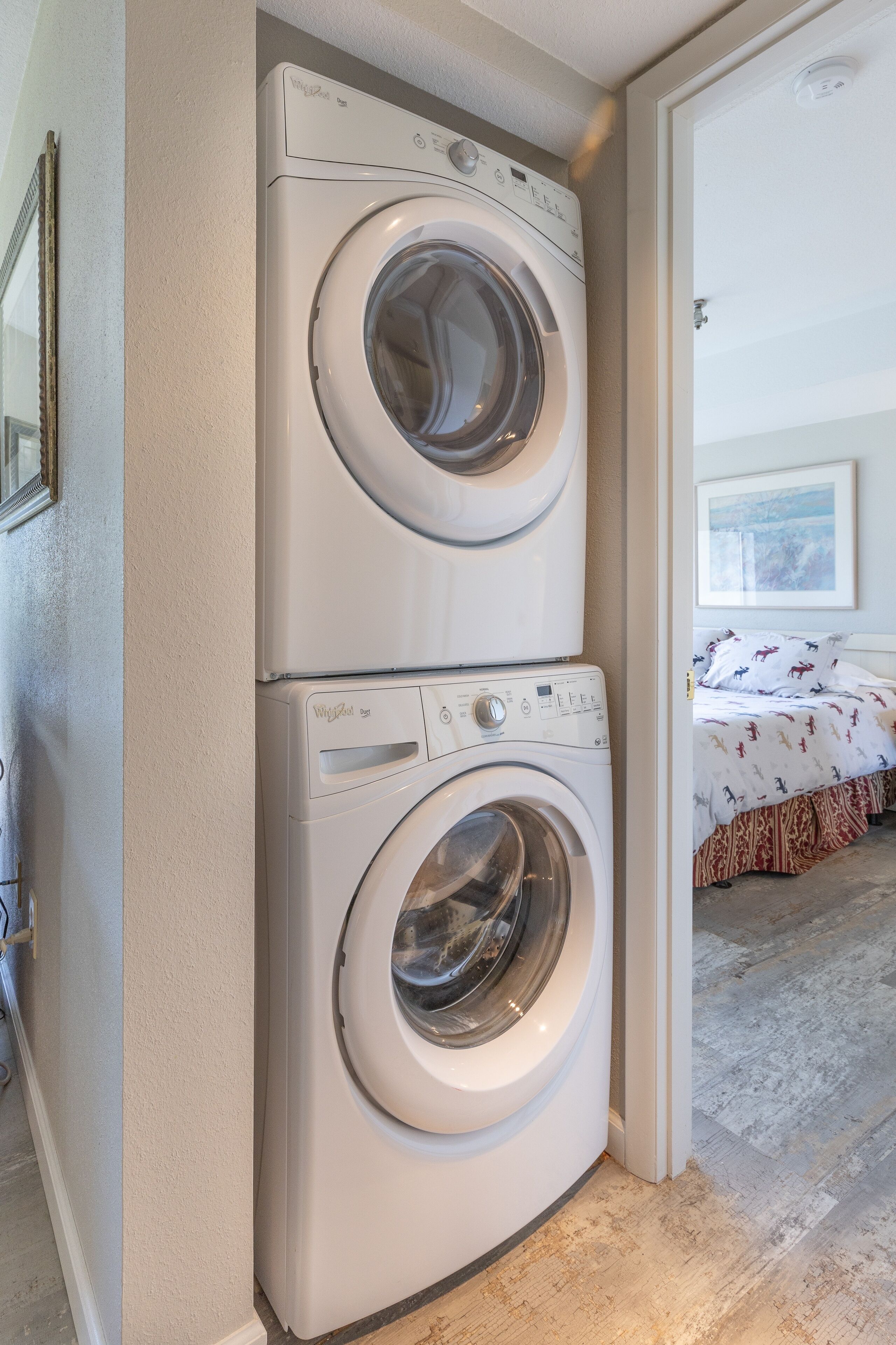 A laundry area with two stacked front-loading washing machines.
