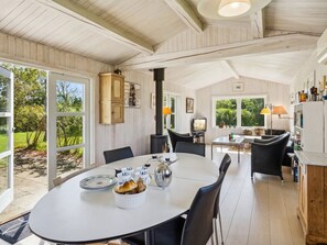A spacious kitchen with a large island, wooden cabinets, and a view of the garden.
