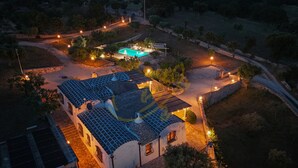 An aerial view of a property with a swimming pool, a covered patio, and a stone wall. - TD Trulli Altura With Pool Stunning Sunsets (Martina Franca)