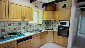 A kitchen with wooden cabinets, a microwave, and a dishwasher.
