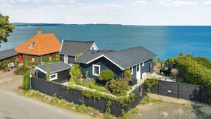 A coastal property with multiple houses, a dock, and a view of the sea. - "Alimpij" - 5m from the sea by Interhome (Børkop)